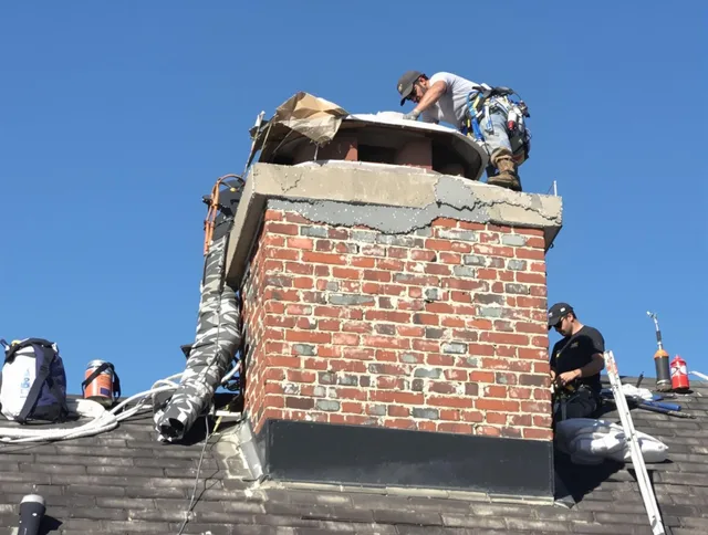 Littleton Chimney Sweep installing a custom chimney crown in Littleton, MA