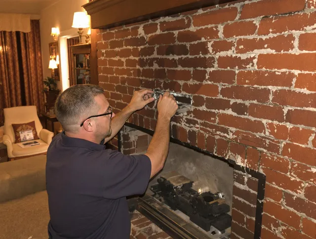 Littleton Chimney Sweep expert fixing a fireplace in Littleton, MA
